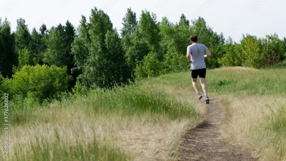 Men in sportswear are running in the park. Outdoor sports. Men in sportswear are running in the park. Outdoor sports.