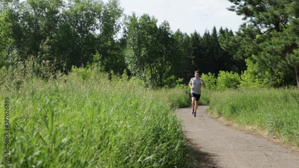 Men in sportswear are running in the park. Outdoor sports. Men in sportswear are running in the park. Outdoor sports.