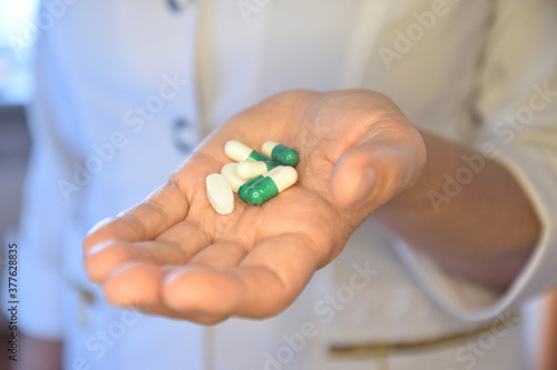 Nurse holding out medication in the palm of her hand