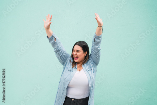 Wallpaper Mural Young plus size woman celebrating victory. Torontodigital.ca
