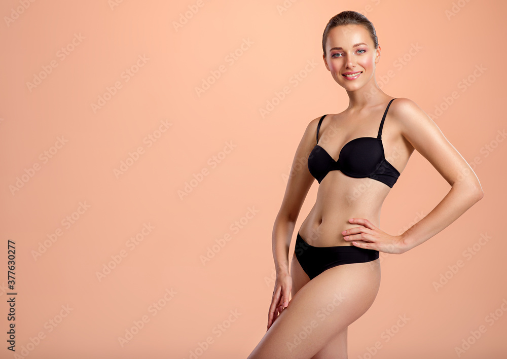 Fototapeta premium Young smiling woman with a beautiful and healthy body. Happy woman with a perfect body.