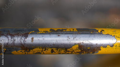 Yellow metal tube worn by use