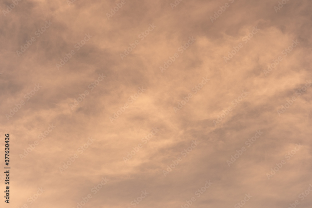 Orange-gold moving clouds abstract background image.