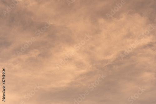 Orange-gold moving clouds abstract background image.