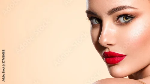Obraz Beautiful white girl with a red lipstick on lips. Stunning brunette girl with long black hair. Closeup face of young beautiful woman with a healthy clean skin. Pretty woman with bright makeup