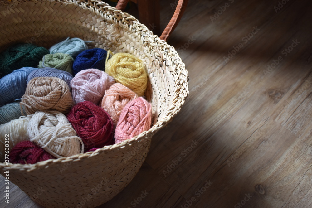 Colorful wool yarns in a basket