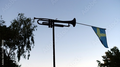 a trumpet with the Swedish flag tucked inside