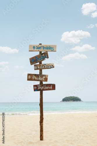 View of wooden signpost on summer tropic beach 