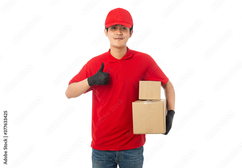 Young Delivery man in red uniform holding paper cardboard box mockup isolated on white background with clipping path.