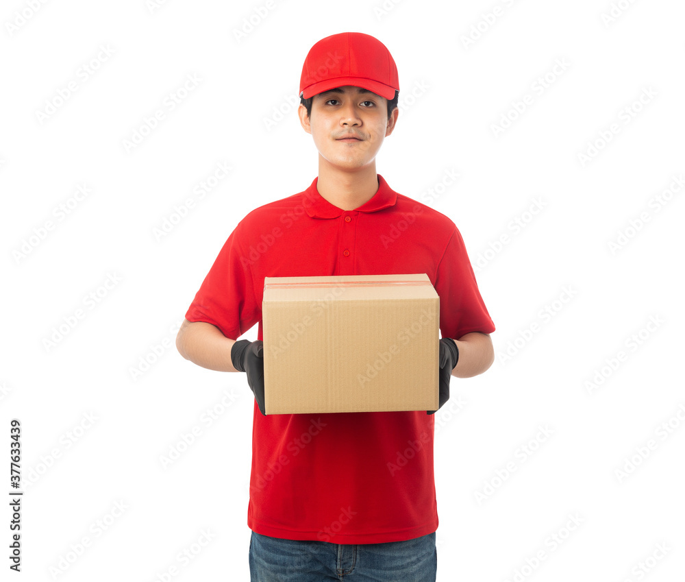 Young Delivery man in red uniform holding paper cardboard box mockup isolated on white background with clipping path. Young Delivery man in red uniform holding paper cardboard box mockup isolated on white background with clipping path.