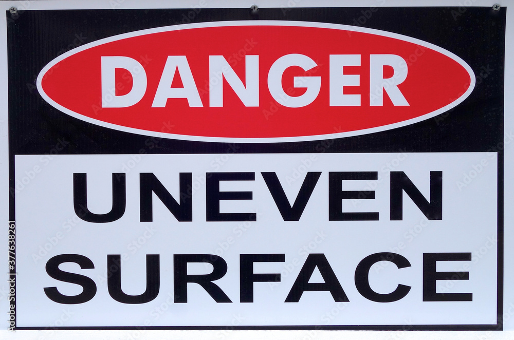 Danger: Uneven surface sign at the beach.