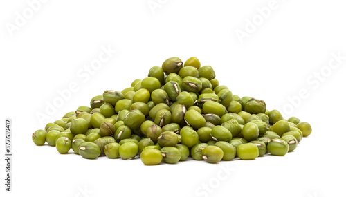 Pile of raw green mung beans seen from liw angle and isolated on white background photo