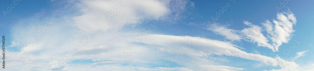 Panoramic of a long white cloud over a large blue sky Panoramic of a long white cloud over a large blue sky