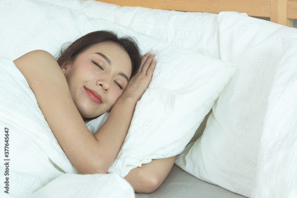 Asian women sleeping and sweet dream on white bed in bedroom Asian women sleeping and sweet dream on white bed in bedroom