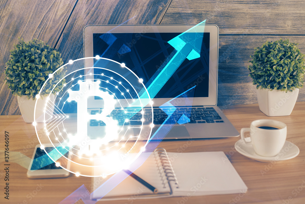 Multi exposure of blockchain theme hologram and table with computer background. Concept of bitcoin crypto currency. Multi exposure of blockchain theme hologram and table with computer background. Concept of bitcoin crypto currency.