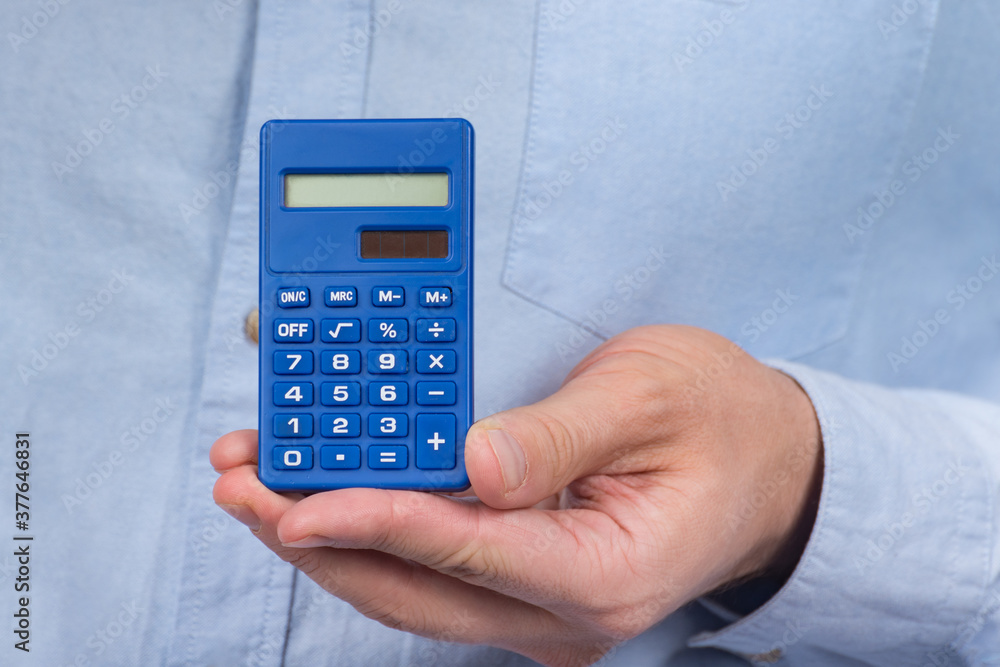 Calculator the hand of man. Close up. Precise calculations. tax calculation investment Calculator the hand of man. Close up. Precise calculations. tax calculation investment