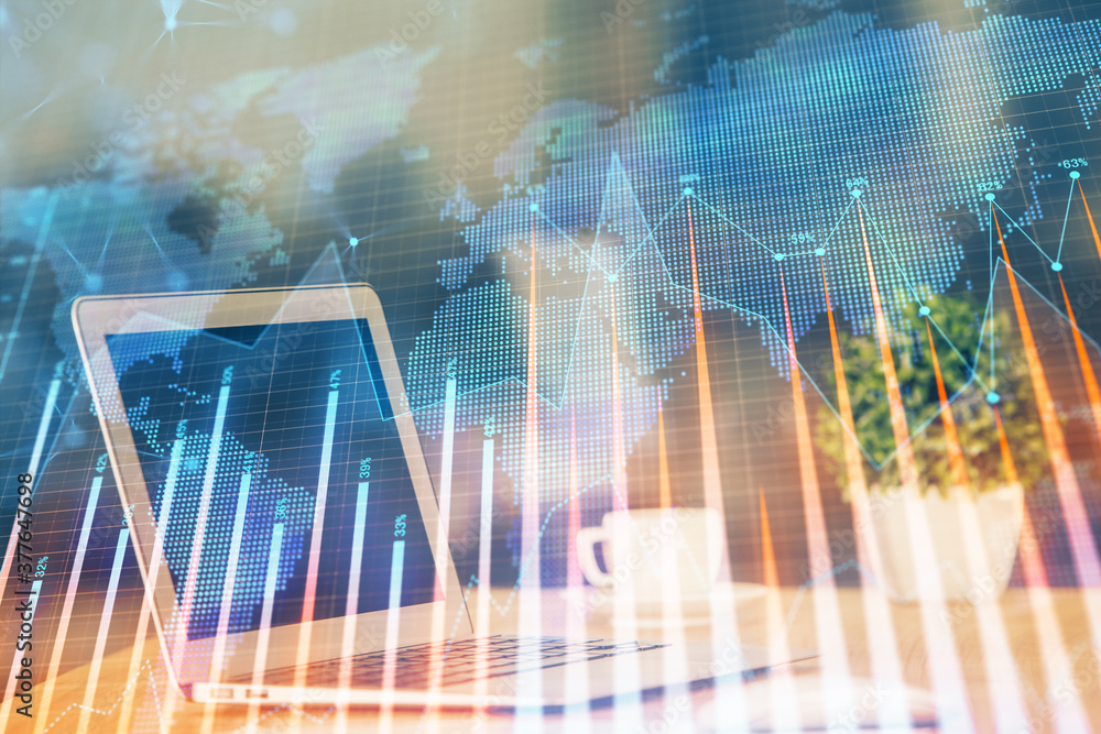 Forex market graph hologram and personal computer on background. Double exposure. Concept of investment. Forex market graph hologram and personal computer on background. Double exposure. Concept of investment.