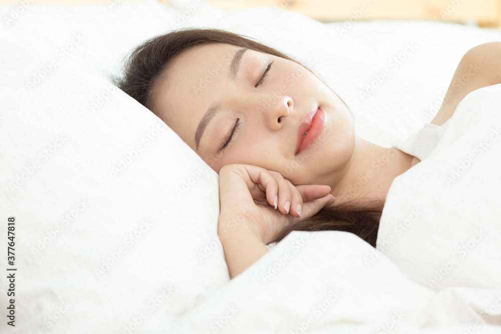 Asian women sleeping and sweet dream on white bed in bedroom Asian women sleeping and sweet dream on white bed in bedroom