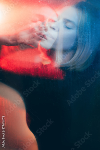 Art portrait. Dream illusion. Double exposure blur silhouette of peaceful woman with closed eyes in red blue bokeh light with old film dust scratches stains effect. Psychedelic trance.