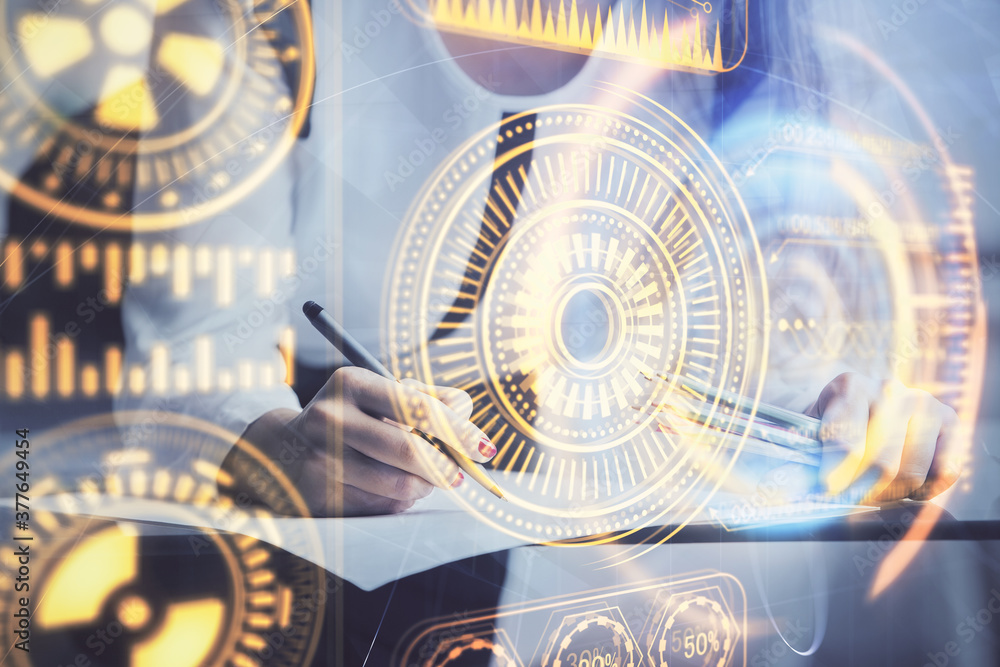 Fototapeta premium Technology theme hologram over woman's hands taking notes background. Concept of Tech. Double exposure