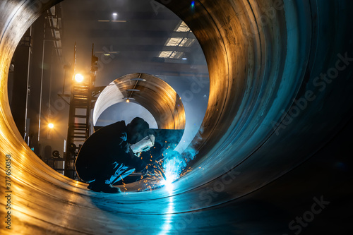 The welder is welding steel plates