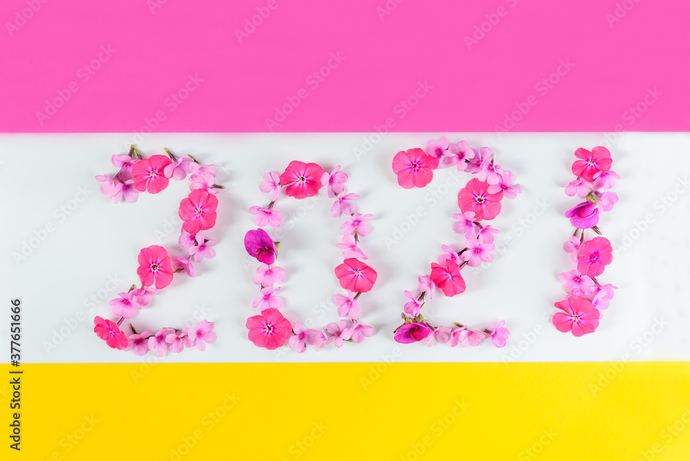 Number 2021 from pink flowers on a multicolored background. New Year concept.