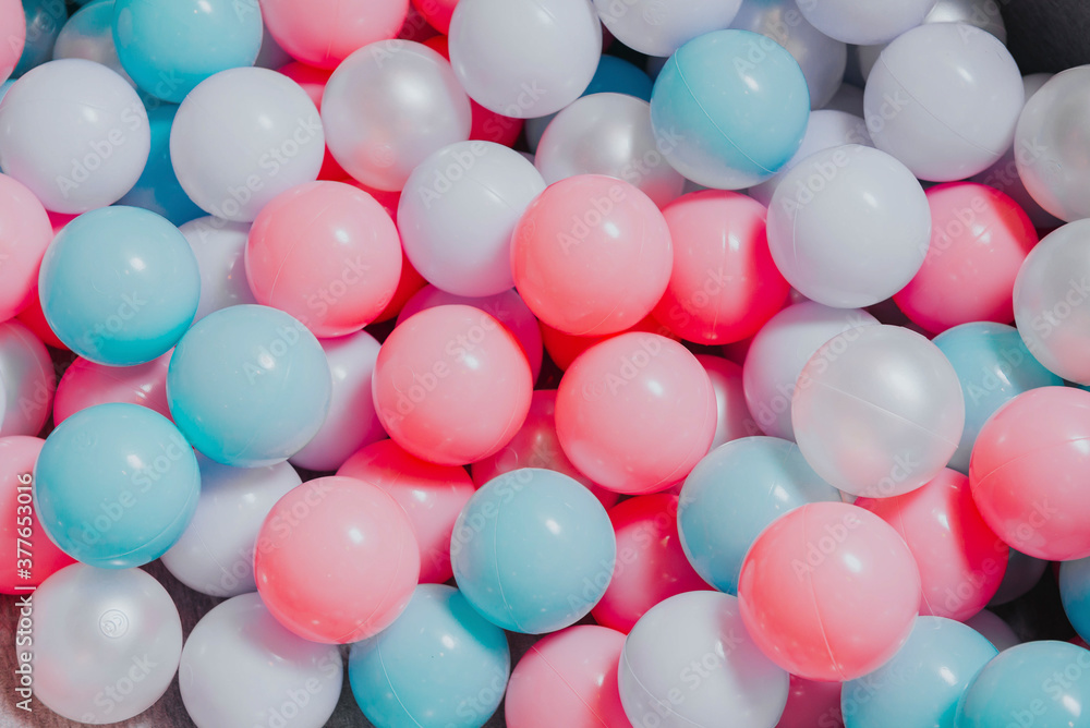 lots of pink, and blue white  plastic balls,