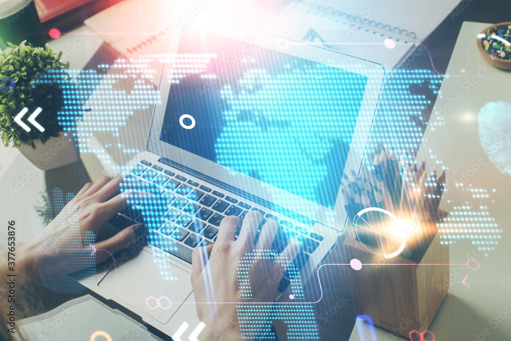 Double exposure of world map hologram with man working on computer on background. Concept of worldwideweb. Double exposure of world map hologram with man working on computer on background. Concept of worldwideweb.