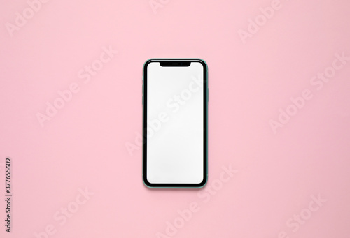 MYKOLAIV, UKRAINE - JULY 07, 2020: iPhone 11 on pink background, top view. Mockup for design photo