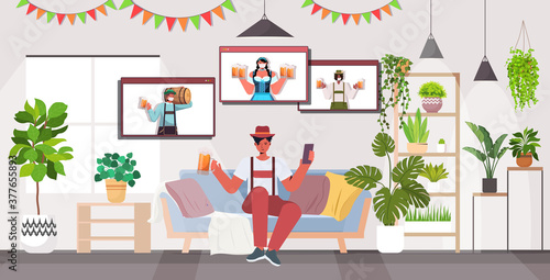 man drinking beer discussing with mix race friends during video call Oktoberfest party celebration coronavirus quarantine self isolation living room interior horizontal vector illustration