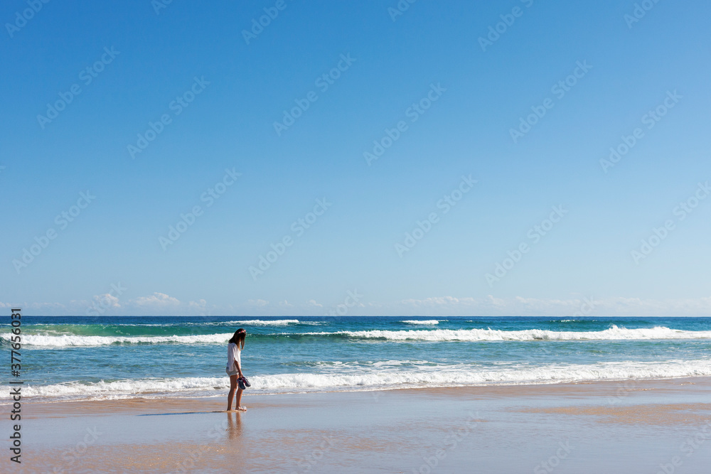 A young woman walking at the beach