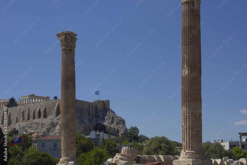 rests of Olympian Zeus temple, with the Athens Acropolis in the background rests of Olympian Zeus temple, with the Athens Acropolis in the background