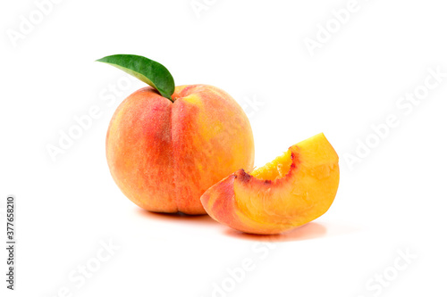 Fresh sweet sliced peach with green leaf isolated on white background.