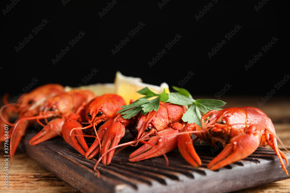 Delicious boiled crayfishes on wooden table, closeup Delicious boiled crayfishes on wooden table, closeup