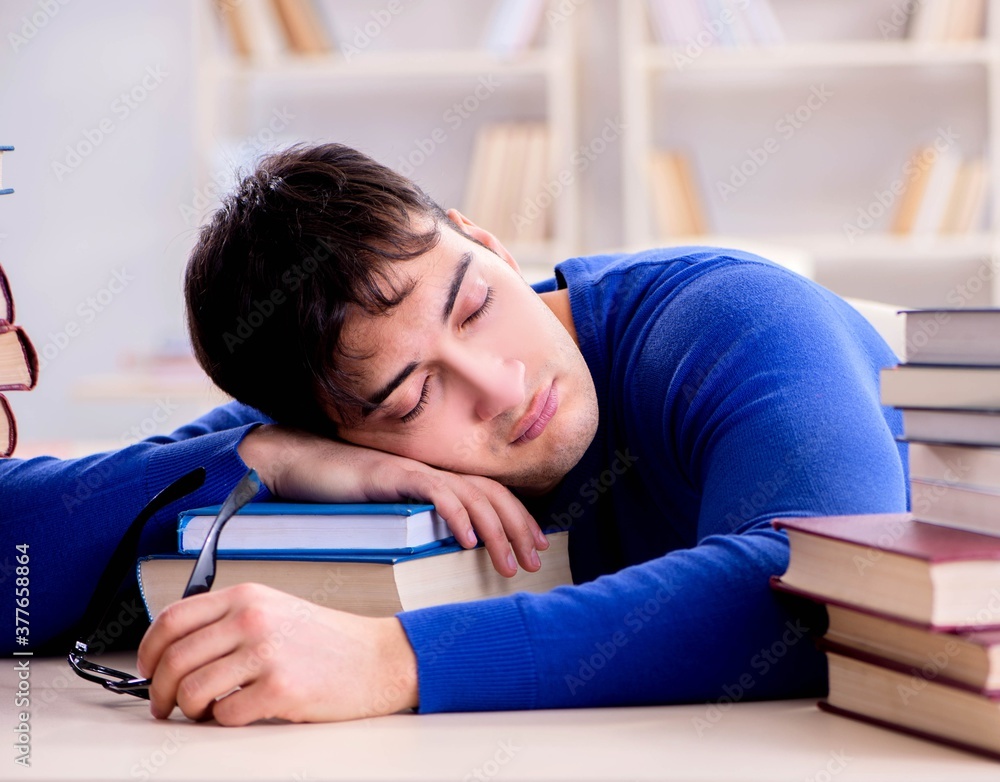 Male student preparing for exams in college library Male student preparing for exams in college library