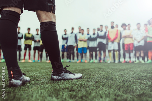 Detail of footballer foots against group of boys during a training photo