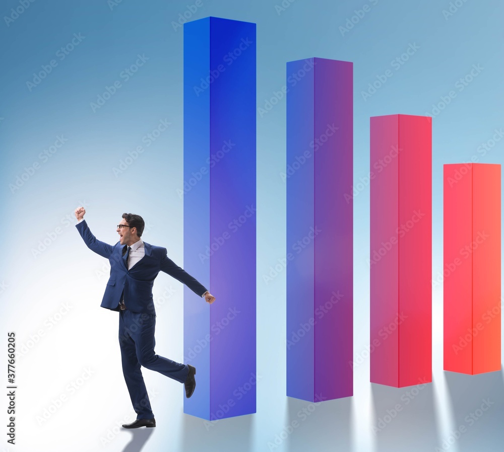 Young businessman in business concept with bar charts Young businessman in business concept with bar charts