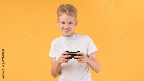 Little boy playing video games at studio
