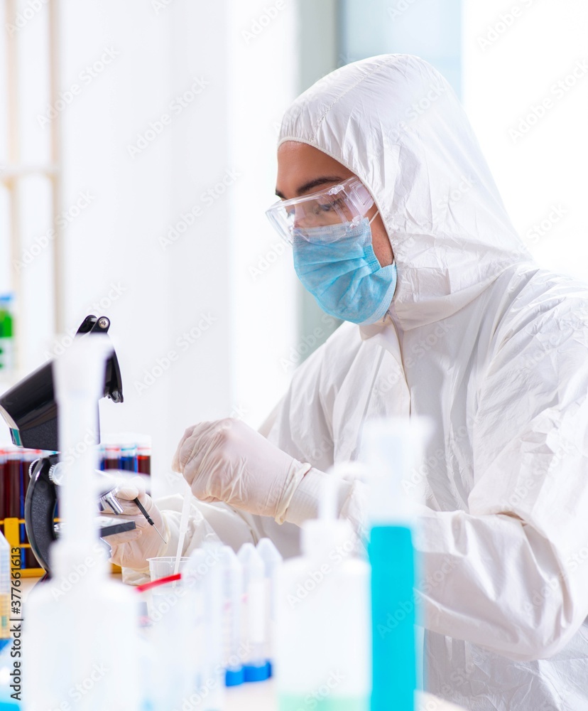 Young chemist student working in lab on chemicals Young chemist student working in lab on chemicals