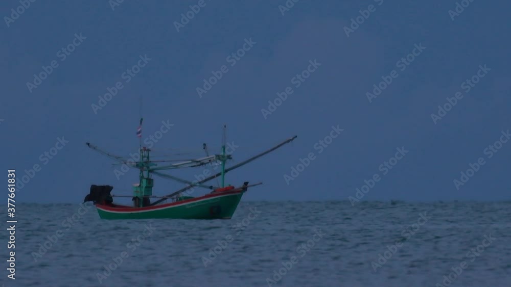 Fishing Boats in Thailand wait in the middle of the ocean for dark to come so they can turn on their green lights and start fishing and troll for shrimps. Fishing Boats in Thailand wait in the middle of the ocean for dark to come so they can turn on their green lights and start fishing and troll for shrimps.