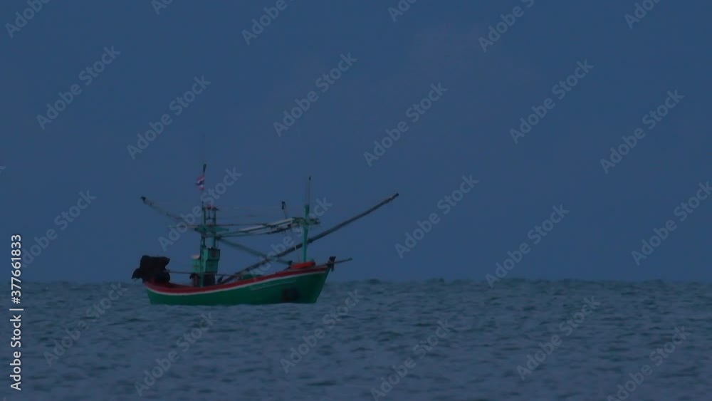 Fishing Boats in Thailand wait in the middle of the ocean for dark to come so they can turn on their green lights and start fishing and troll for shrimps. Fishing Boats in Thailand wait in the middle of the ocean for dark to come so they can turn on their green lights and start fishing and troll for shrimps.