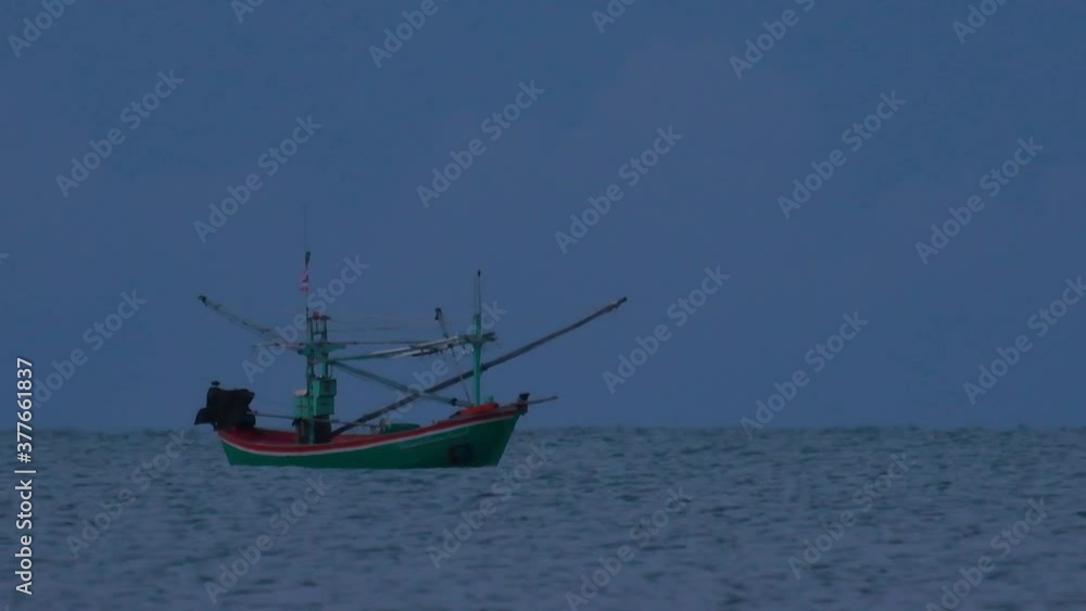 Fishing Boats in Thailand wait in the middle of the ocean for dark to come so they can turn on their green lights and start fishing and troll for shrimps. Fishing Boats in Thailand wait in the middle of the ocean for dark to come so they can turn on their green lights and start fishing and troll for shrimps.