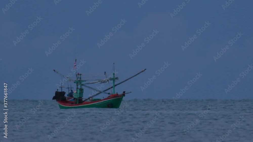 Fishing Boats in Thailand wait in the middle of the ocean for dark to come so they can turn on their green lights and start fishing and troll for shrimps. Fishing Boats in Thailand wait in the middle of the ocean for dark to come so they can turn on their green lights and start fishing and troll for shrimps.