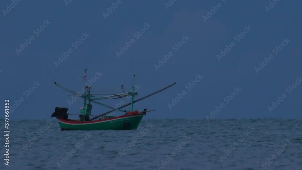 Fishing Boats in Thailand wait in the middle of the ocean for dark to come so they can turn on their green lights and start fishing and troll for shrimps. Fishing Boats in Thailand wait in the middle of the ocean for dark to come so they can turn on their green lights and start fishing and troll for shrimps.