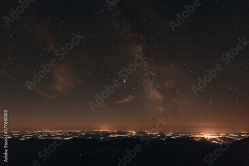 Milky way galaxy and the city from the mountain