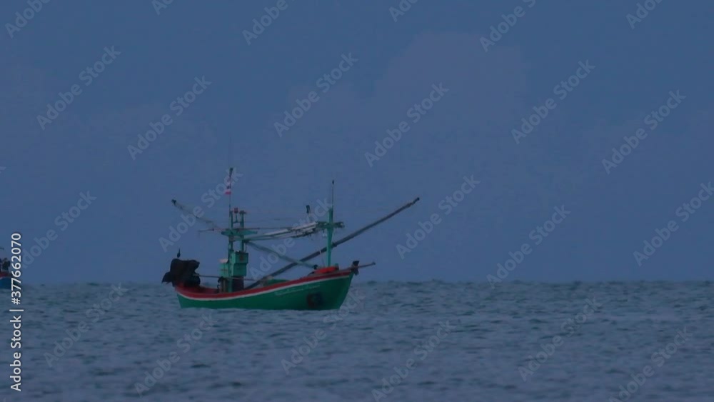 Fishing Boats in Thailand wait in the middle of the ocean for dark to come so they can turn on their green lights and start fishing and troll for shrimps. Fishing Boats in Thailand wait in the middle of the ocean for dark to come so they can turn on their green lights and start fishing and troll for shrimps.