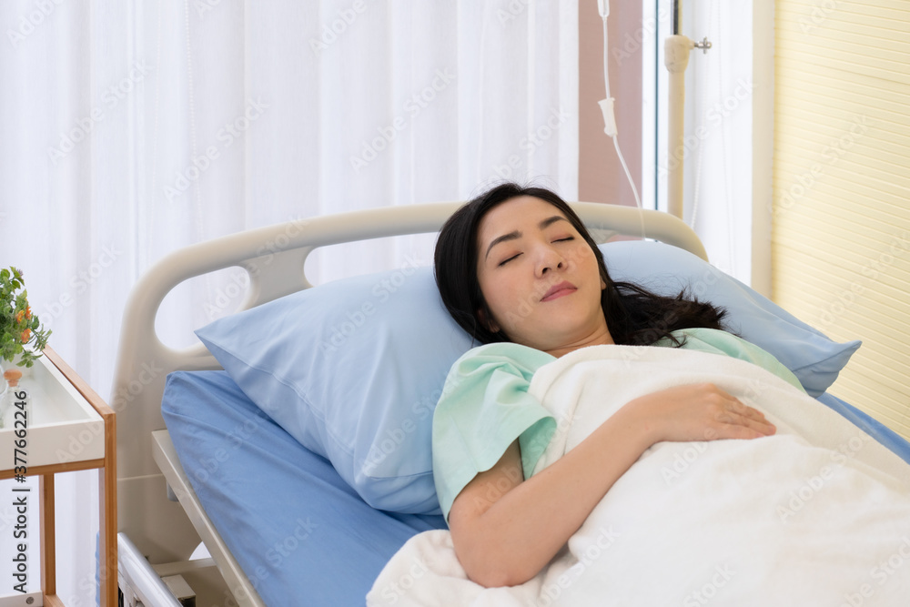 asian woman is sick and lie in hospital bed. healthcare and medical concept asian woman is sick and lie in hospital bed. healthcare and medical concept