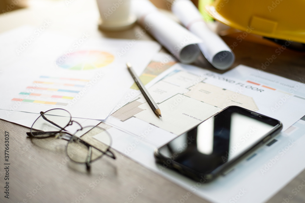 Architect's desk, Analysis of house building designs, Focus on the pencil, Close-up.