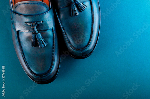 Blue loafer shoes on blue background. One pair. Top view.