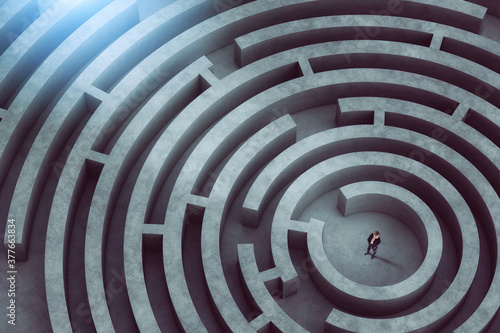 Confused businessman thinks how to find the right way to exit from a big maze